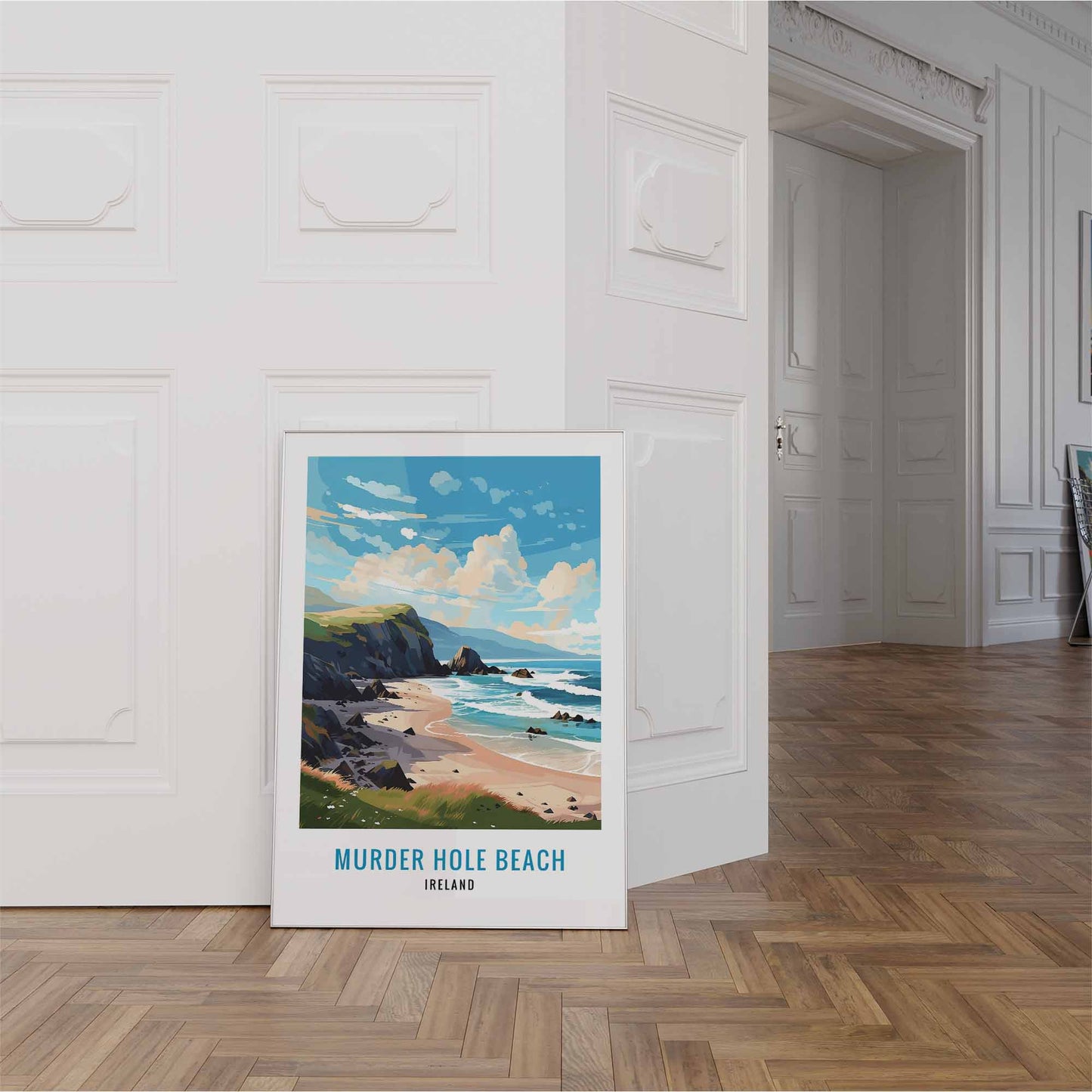 Framed artwork of Murder Hole Beach, Ireland on a wall in a room with wooden flooring.